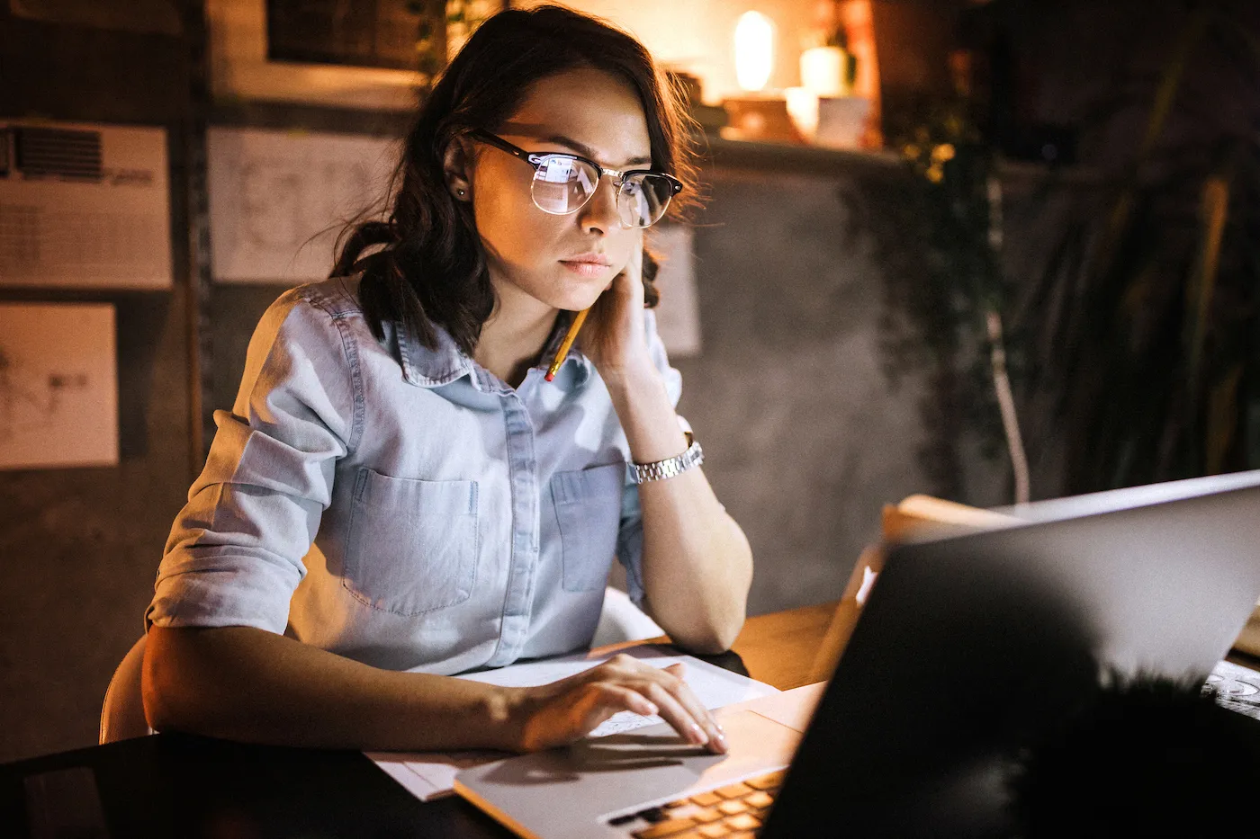 Young woman checking her credit report and reviewing negative items on her credit report using her laptop.