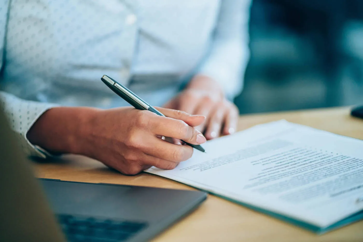 Woman signing a personal loan paper.