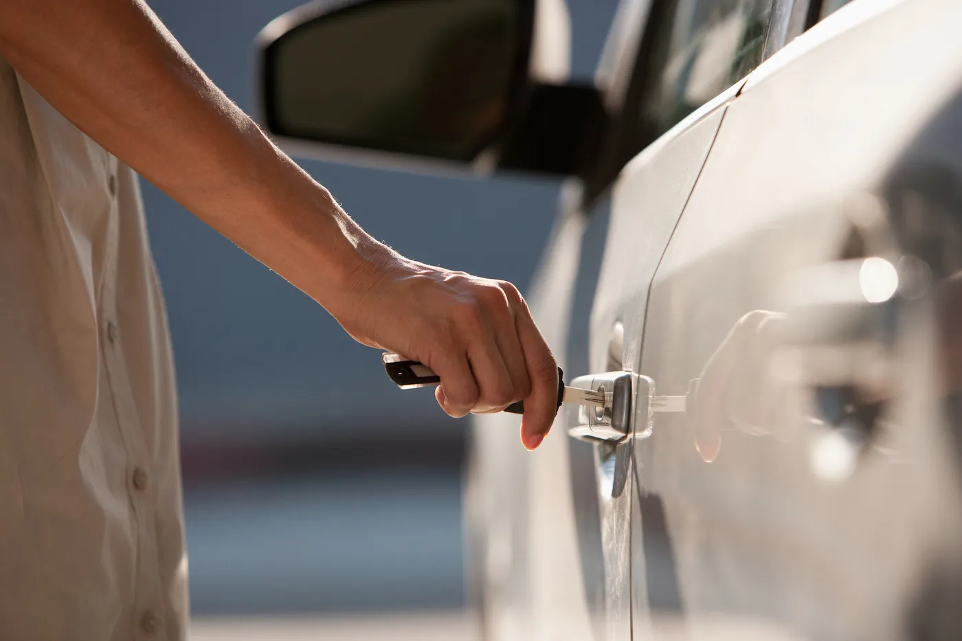 Woman opening a car door