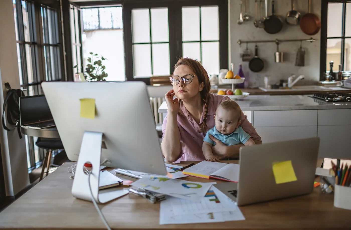 Mother with her baby boy working on her finances