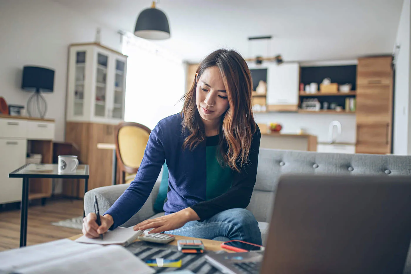 Woman writing on notepad.