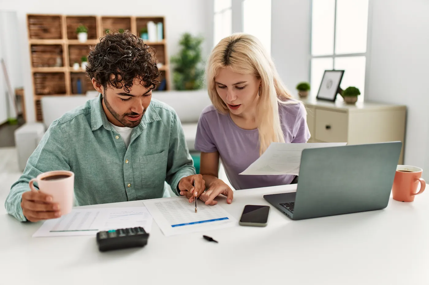 Young couple working on taxes, determining if they are eligible for the saver's credit