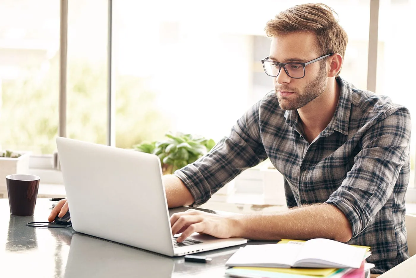 A man using a laptop to review his finances.