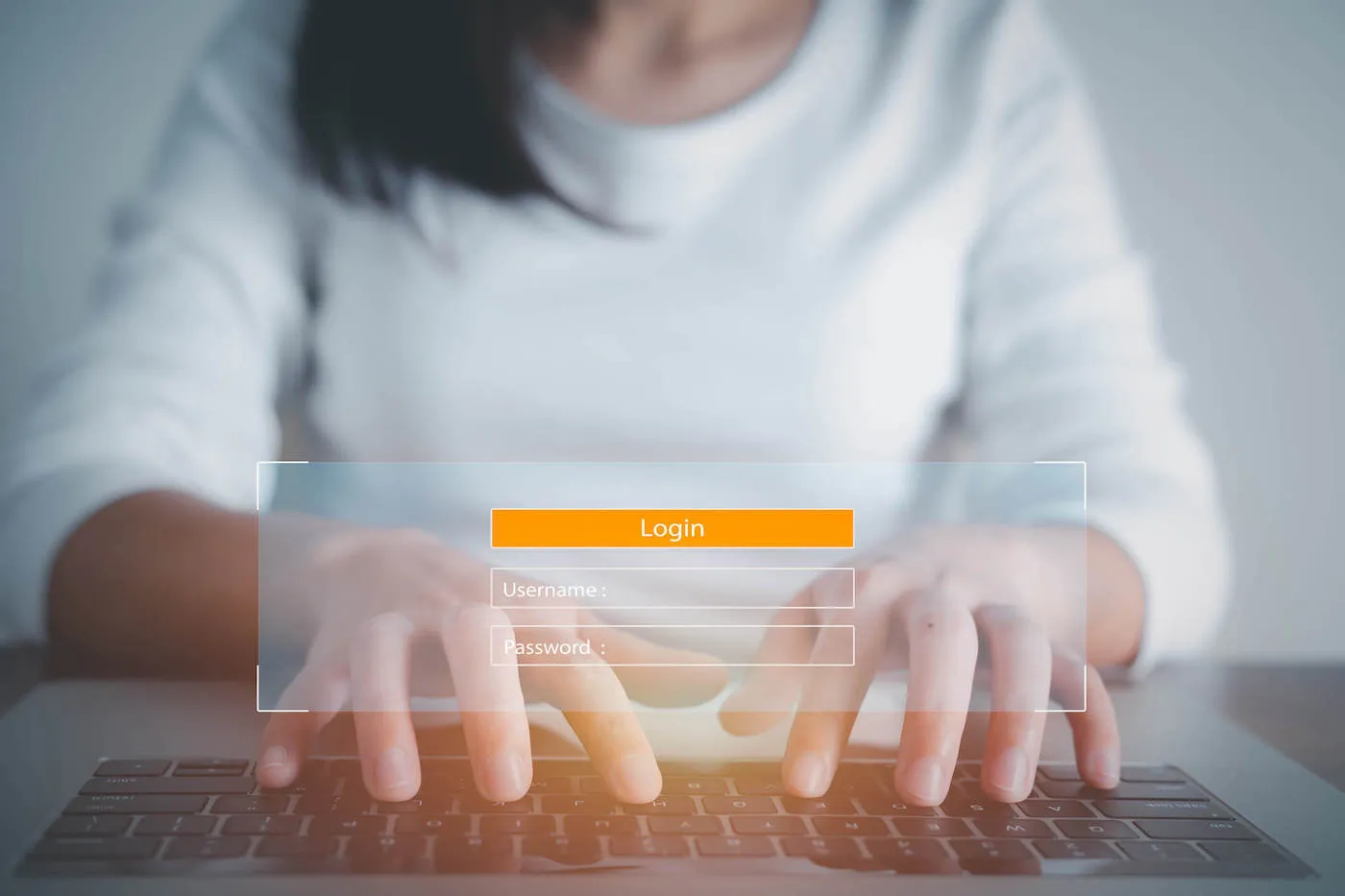 Young woman typing on keyboard engaged in online bill pay.