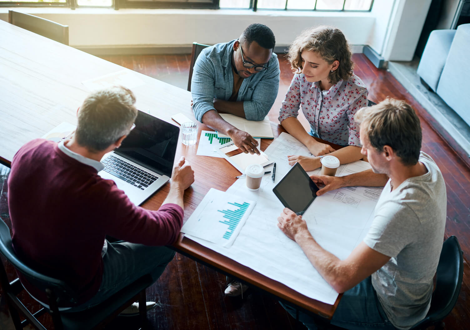 Overhead example image of composition overview with a small group of colleagues working together at a table