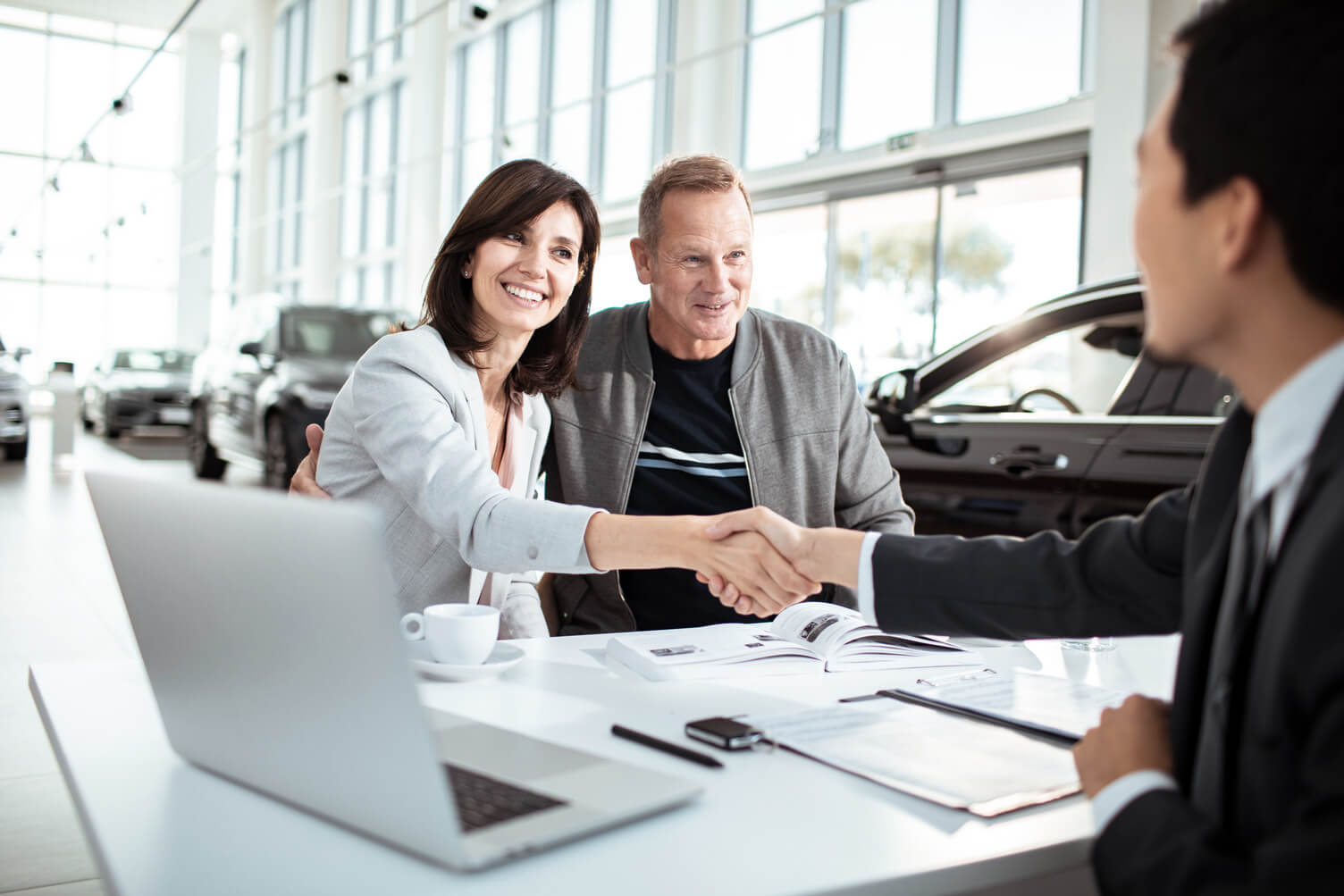 couple at dealership talking to dealer