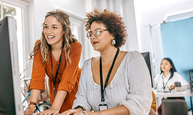 female-coworkers-discussing-creative