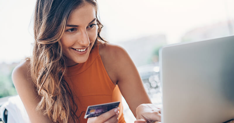 woman-with-creditcard-looking-at-laptop