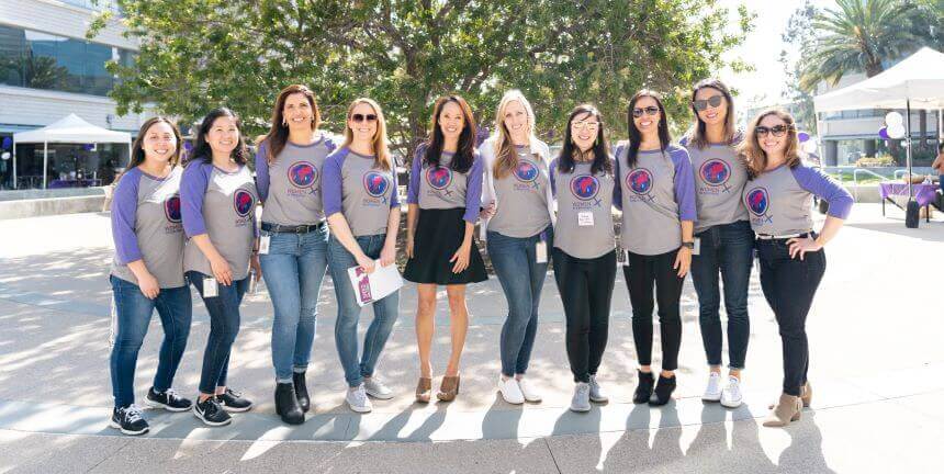 A picture of ten women employees wearing the Women in Experinan t-shirts