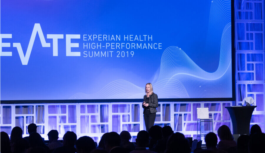 Keynote speaker delivering speech at the Experian Health High-Performance Summit in 2019
