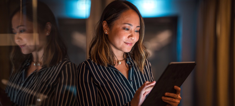 woman looking at tablet