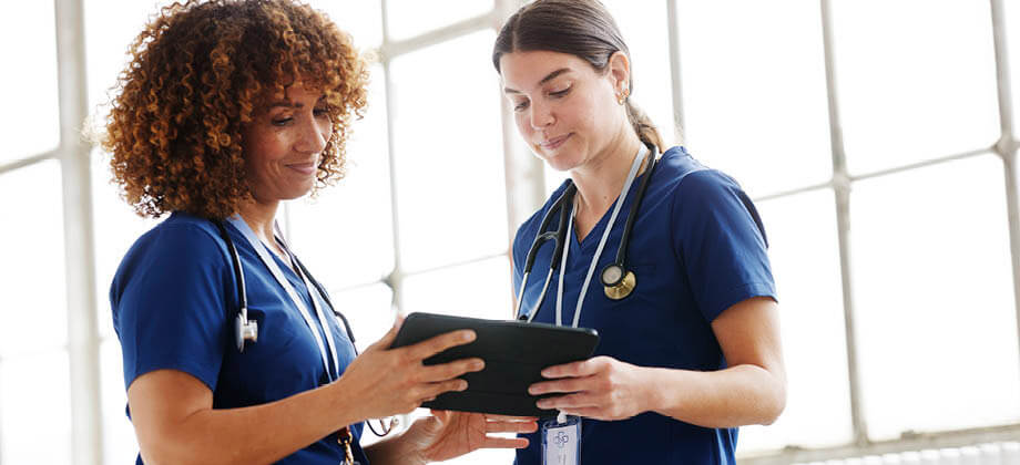 female nurses looking at a virtual chart via tablet