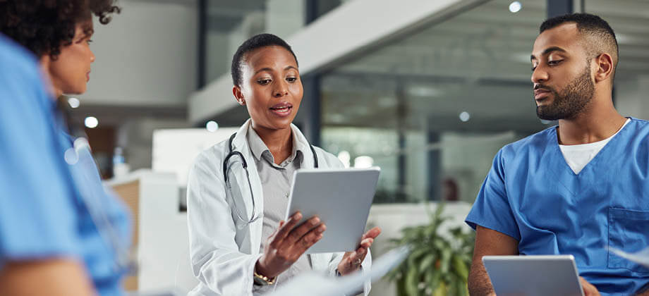 A group of medical professionals reviewing a clipboard