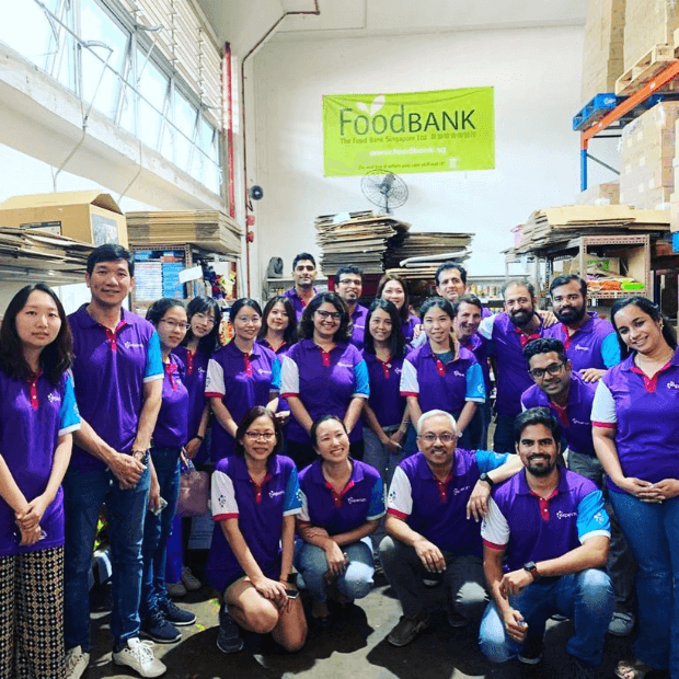 11 of 20 logos - People in Experian t shirts at a Food Bank